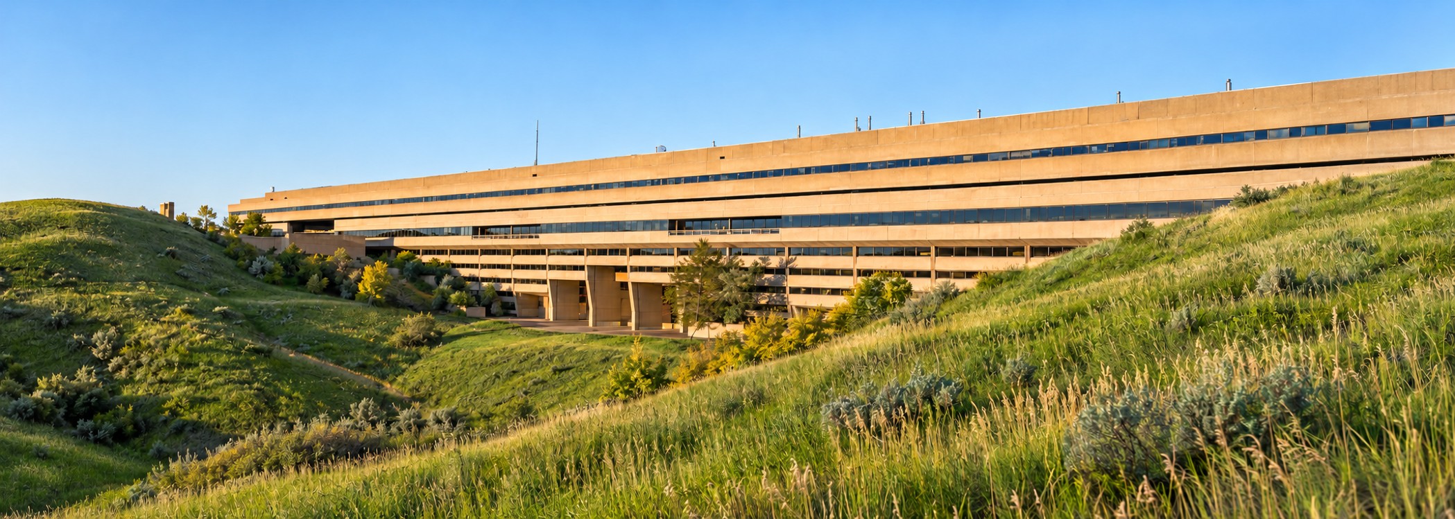 AI-generated visualization of University Hall beside green coulees